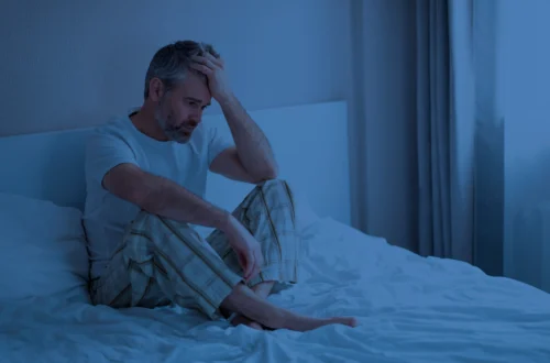 Man with insomnia awake at night because of frequent urination at night — visual representation of nocturia and prostate health issues.